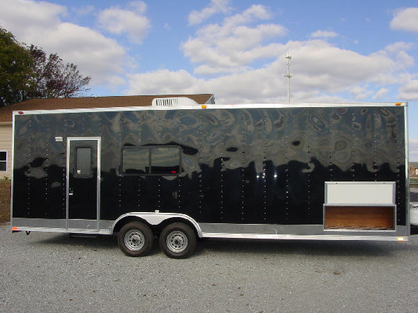 An Exterior picture of the Millennium Escape toy hauler trailer,Black tandem axle.