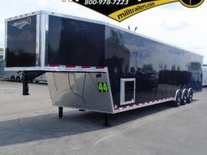 Black gooseneck race trailer with triple axles, generator door