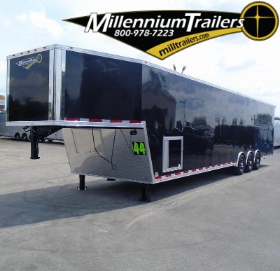 Black gooseneck race trailer with triple axles, generator door