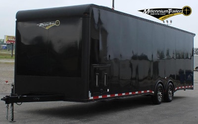 Enclosed Car Hauler 2023 30' Front Exterior Roadside View. Black .040 Screwless Exterior, Generator Door, Aluminum Wheels, Black-Out Package.