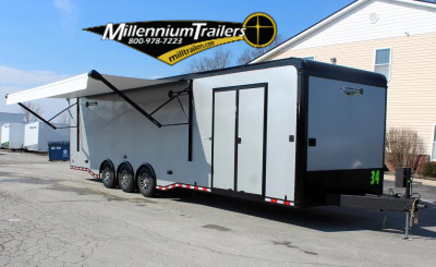 Enclosed Car Hauler 2024 34' Edge Front Curbside View. It features extended electric awning, silver bonded exterior, electric tongue jack, & aluminum wheels.