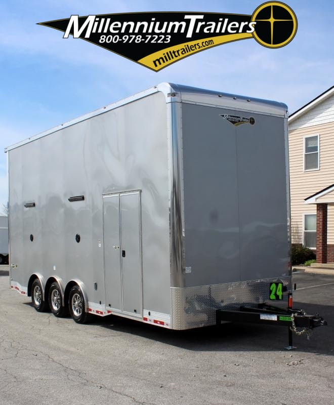 Enclosed Stacker Trailer Front Curbside View 2024 24' Silver Eliminator. It features double side-doors, aluminum wheels, bonded exterior, speakers & L.E.D. lighting.