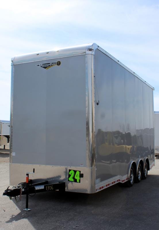 Enclosed Stacker Trailer Front Curbside View 2024 24' Silver Eliminator. It features an antenna, aluminum wheels, bonded exterior, & L.E.D. lighting.