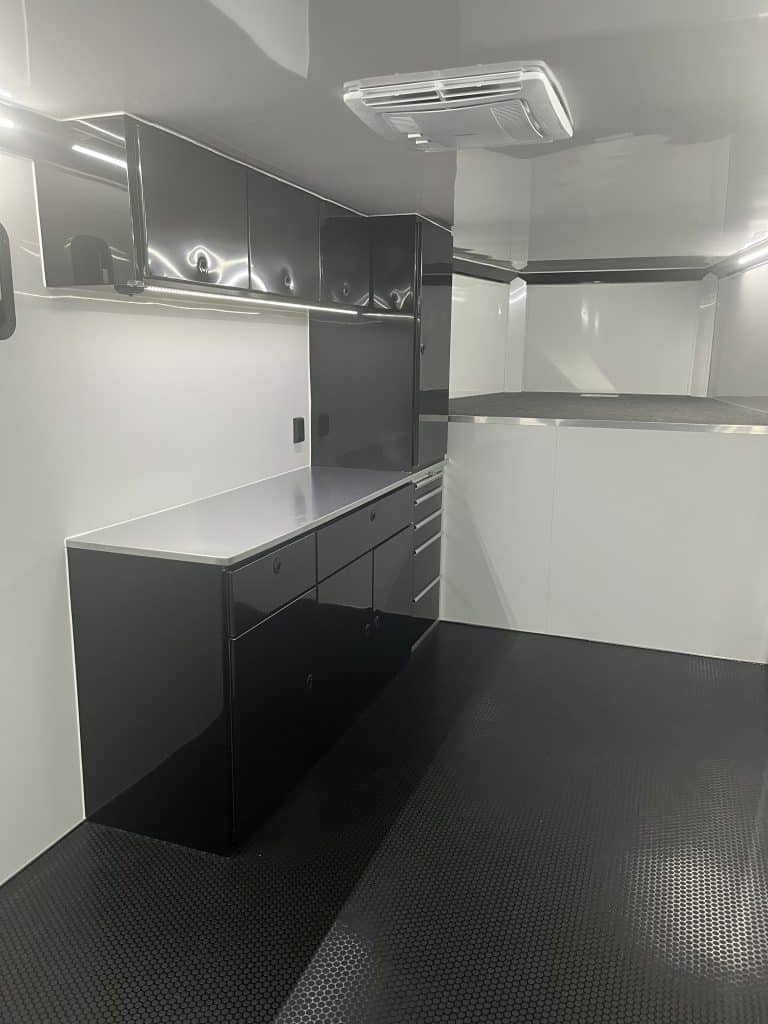 Upper and lower black cabinets with overhead A/C